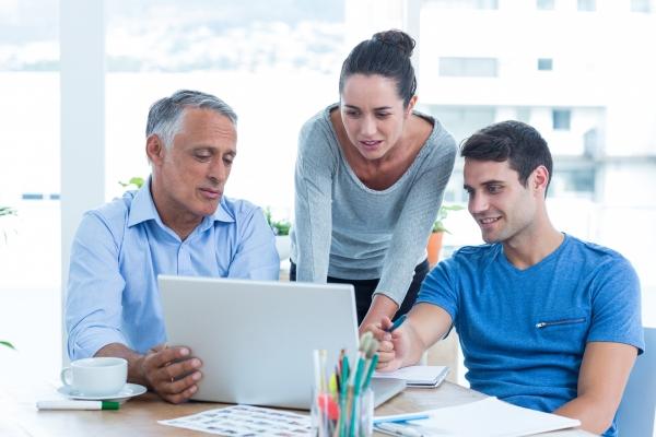 Team of 3 Viewing Laptop