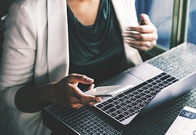 Woman on Laptop and Phone